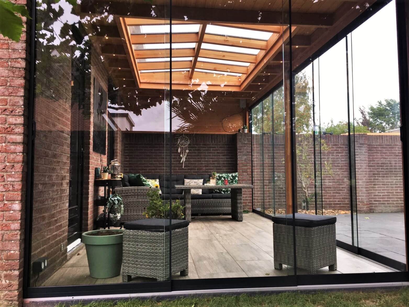 Houten overkapping met lichtstraat zadeldak en glazen schuifwanden antraciet